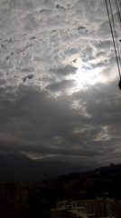 Caracas hillside neighborhoods documented under cloudy afternoon skies