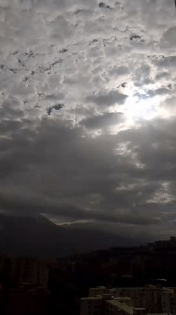 Caracas hillside neighborhoods documented under cloudy afternoon skies