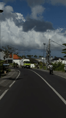 Scooter rider observed on North Kuta street during cloudy day