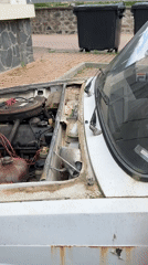 Man tends to broken-down car in Bulgarian town