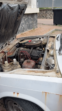 Man tends to broken-down car in Bulgarian town