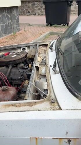 Man tends to broken-down car in Bulgarian town