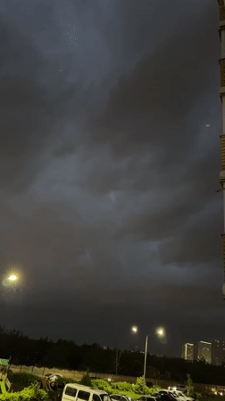 Rainy evening documented in Krasnodar with vehicles and candy