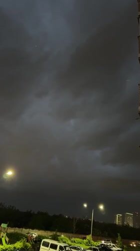 Rainy evening documented in Krasnodar with vehicles and candy
