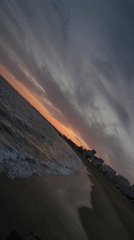 Dusk at Quarteira's rocky shore, moon rising over the Atlantic