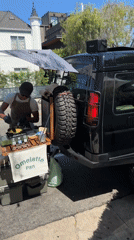 Street-side omelette cooking from a cart hitched to an SUV