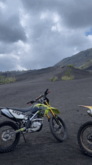 Dirt bikers gather on volcanic terrain in Kintamani