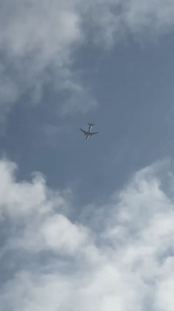 Commercial flight passing through cloudy skies over Karachi