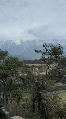 Bridge construction underway in Rait against mountain backdrop