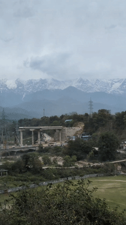 Bridge construction underway in Rait against mountain backdrop