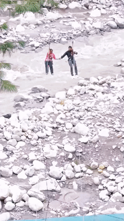 Zip-lining over a rocky Himalayan river in Palchan, India