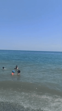 Busy pebble beach day on the Aegean, northern Greece