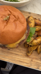 Burger meal documented on wooden board in Los Angeles
