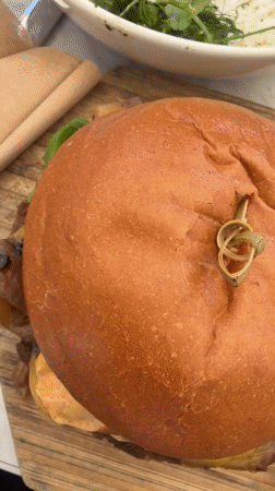 Burger meal documented on wooden board in Los Angeles