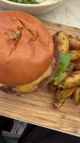 Burger meal documented on wooden board in Los Angeles
