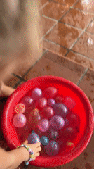 Children enjoy water balloon play on patio in Vietnam