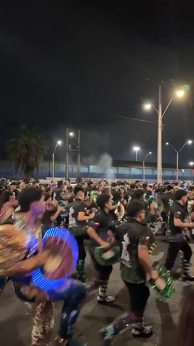 Costumed dancers perform at nighttime street festival in Arica