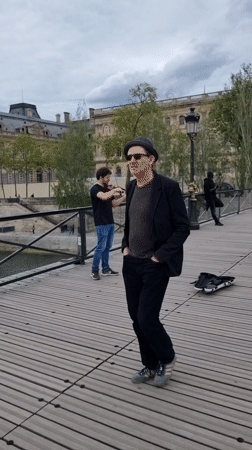 Street musician performs along Seine as Parisians enjoy riverside afternoon