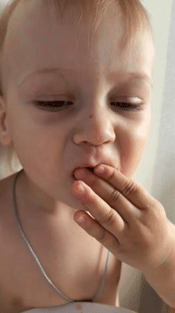 Toddler enjoys breakfast sandwich in Moscow suburb
