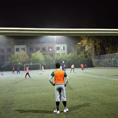 Night soccer game observed on illuminated Coventry field