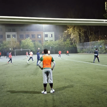 Night soccer game observed on illuminated Coventry field