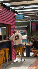 Man sits at outdoor bar in São Paulo