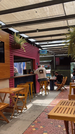 Man sits at outdoor bar in São Paulo