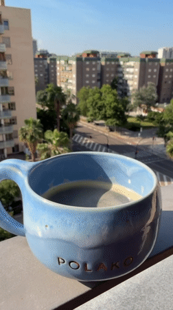 Morning coffee ritual captured from Valencia balcony overlook