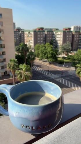 Morning coffee ritual captured from Valencia balcony overlook