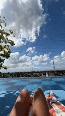Woman sunbathes by infinity pool in Kuta, Indonesia