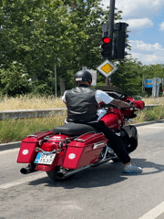 Red touring bike rolls through Veliko Tarnovo on a summer morning