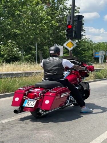 Red touring bike rolls through Veliko Tarnovo on a summer morning