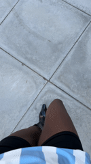 Person films self walking in Palm Desert wearing striped top