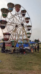 Outdoor carnival underway on a grassy field in Boyolangu