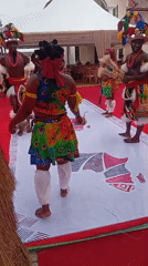 Traditional dancers perform at village entrance in Nigeria