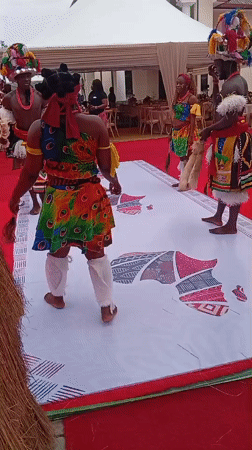 Traditional dancers perform at village entrance in Nigeria