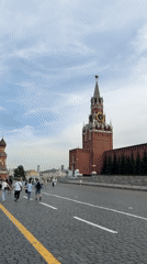 Pedestrians walk cobblestone path near St. Basil's Cathedral, Moscow