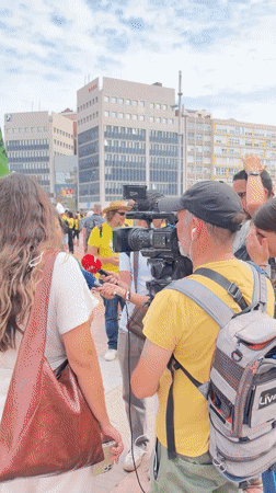 Yellow-shirted demonstrators gather near Barcelona's Palau Nacional amid police presence