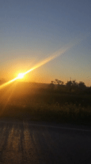 Rural sunset captured in time-lapse and car mirror reflections