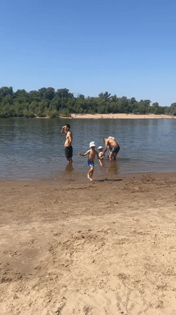 Sunny river beach day in Kilyakovka, Russia