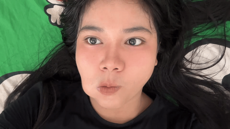 Woman and white cat share quiet moments in North Jakarta
