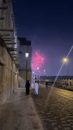 Fireworks display captured on Dubai cobblestone street