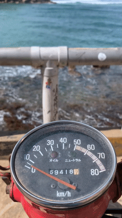 High-mileage motorbike rider captures ocean view in Sri Lanka