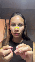 Woman applies facial wax strips during beauty treatment in Fethiye