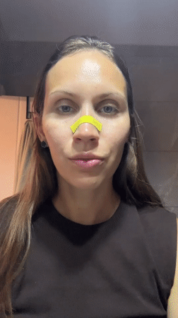 Woman applies facial wax strips during beauty treatment in Fethiye