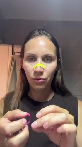 Woman applies facial wax strips during beauty treatment in Fethiye