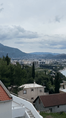 Man enjoys balcony moment overlooking Montenegro coastline