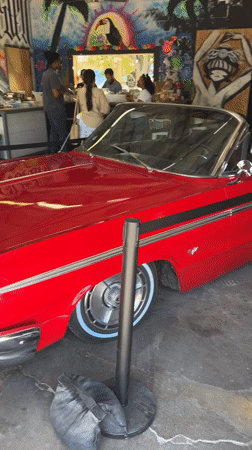 Red convertible parked inside a graffiti-covered El Paso venue