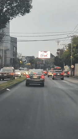 Wet road traffic documented in Mexico City overnight