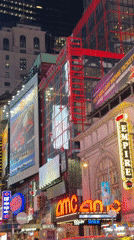 Times Square blazes with neon signs and billboard ads at night